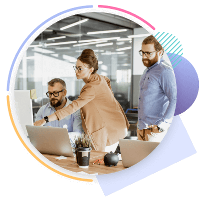 3 people in an office looking at a computer screen