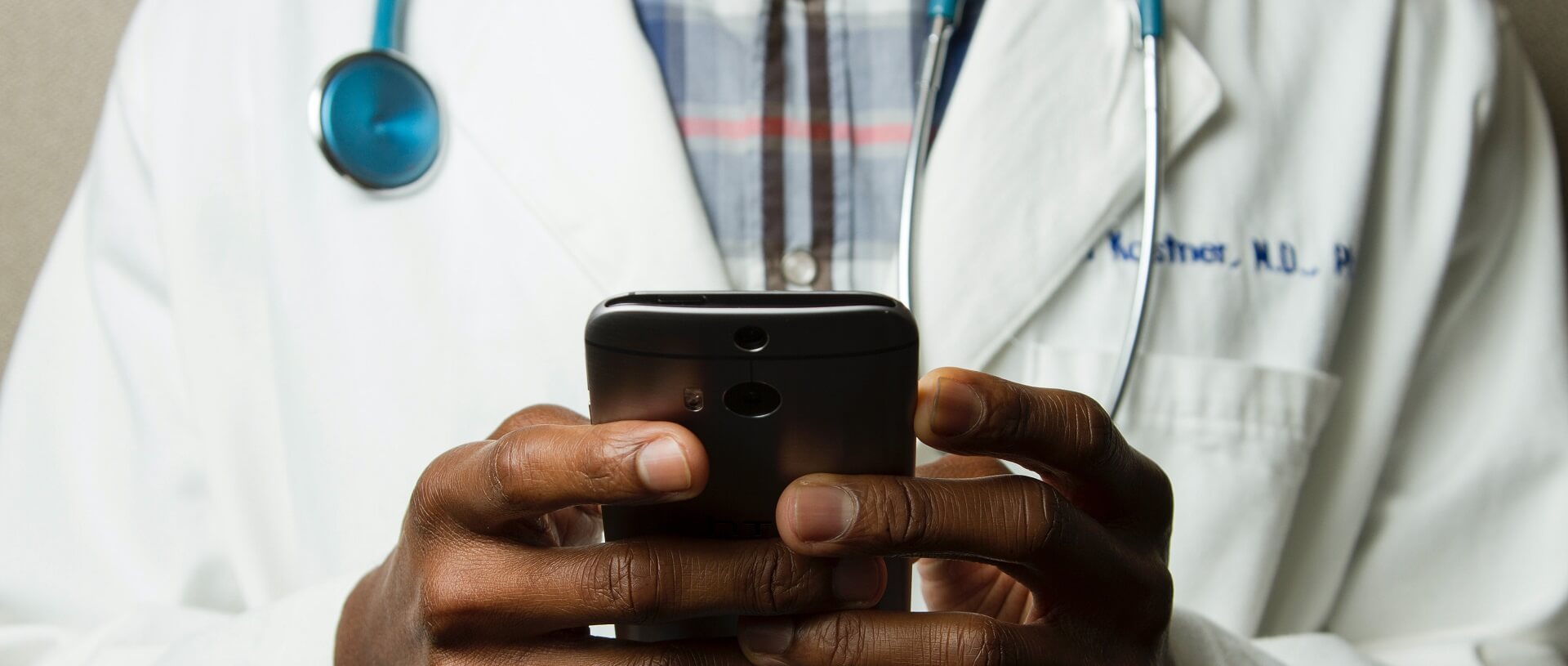 Photo of doctor holding mobile