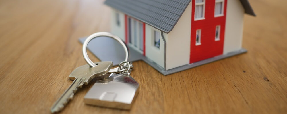 Photo of toy house and house keys representing mortgage