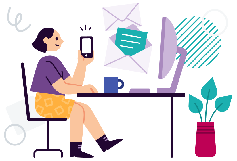 image if a person at a desk on their computer and using a mobile phone