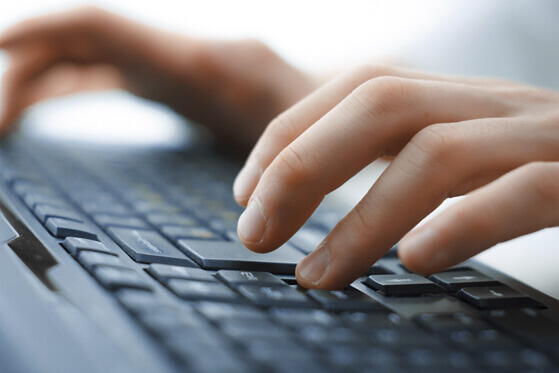 hands typing on a keyboard