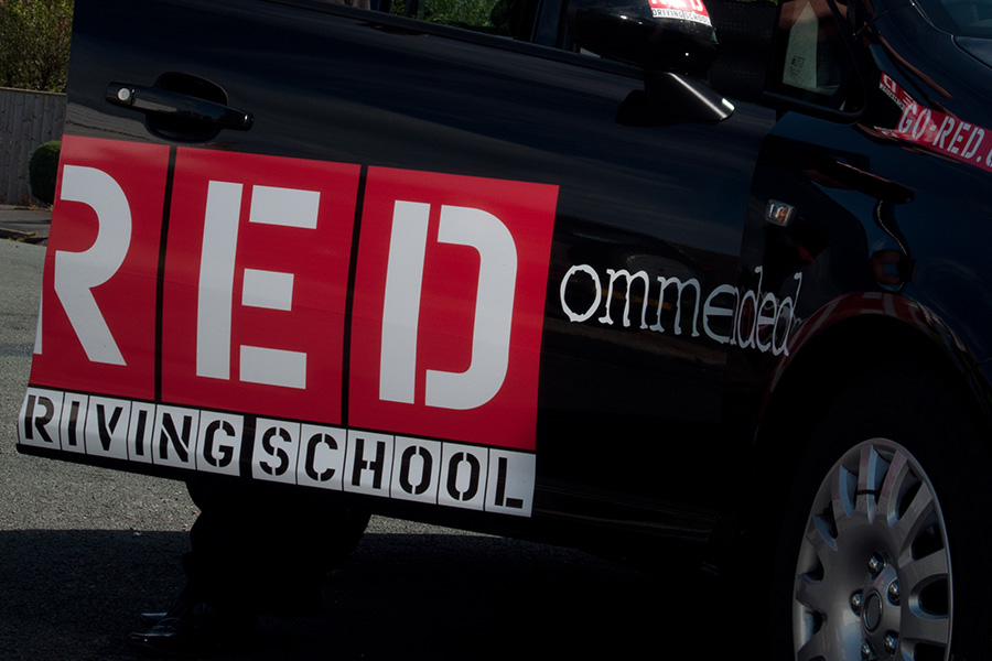 car branded red driving school